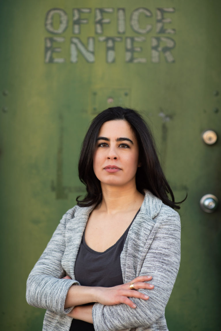 Roxanne Khamsi against a green background